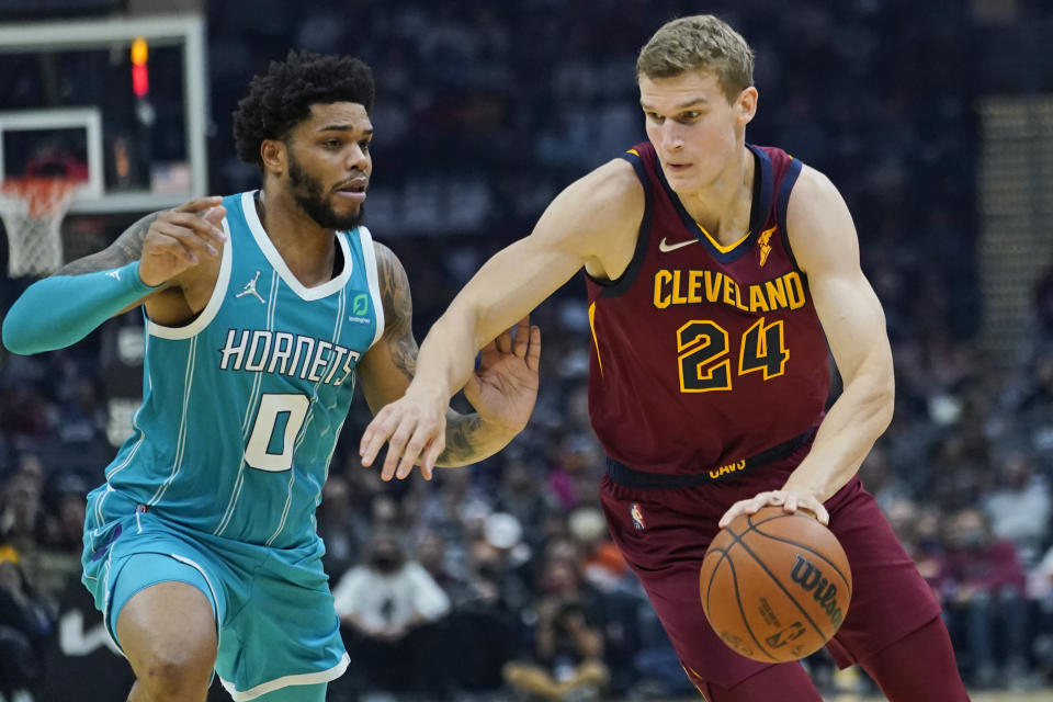 Cleveland Cavaliers' Lauri Markkanen (24) drives against Charlotte Hornets' Miles Bridges (0) in the first half of an NBA basketball game, Friday, Oct. 22, 2021, in Cleveland. (AP Photo/Tony Dejak)