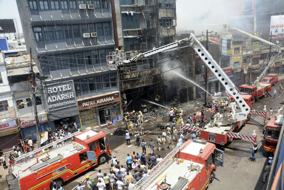 Firefighters douse a fire which broke out in a restaurant and hotel near the Patna Junction railway station, in Patna, Bihar, India, Thursday, April 25, 2024. (AP Photo/Aftab Alam Siddiqui)