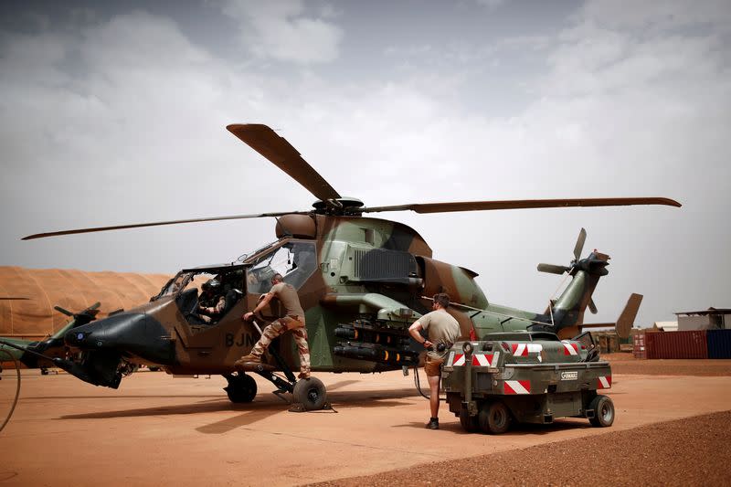 FILE PHOTO: French soldiers work on a Tiger attack helicopter at the Operational Desert Plateform Camp (PfOD) during the Operation Barkhane in Gao