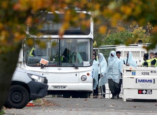 A view of people thought to be migrants at the Manston immigration short-term holding facility located at the former Defence Fire Training and Development Centre in Thanet, Kent