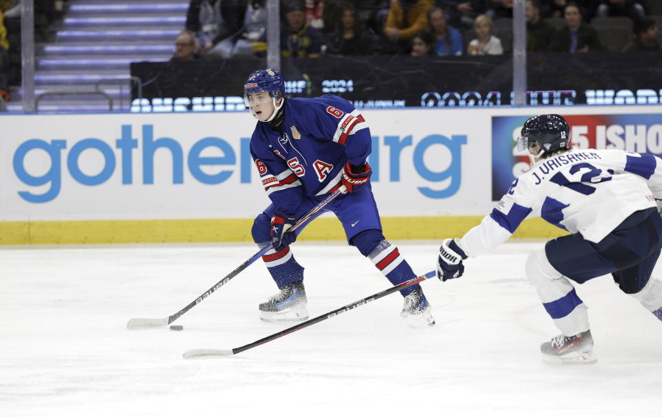 USA's Will Smith, left, and Finland's Joona Väisänen during the IIHF World Junior Championship ice hockey semifinal match between USA and Finland at Scandinavium in Gothenburg, Sweden, Thursday, Jan. 4, 2024. (Adam Ihse/TT via AP)