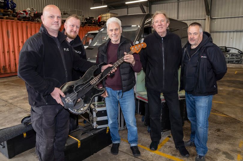 PC Paul Gerrish and PC Phil Pentelow hand back the bass guitar to Phil Mitchell alongside drummer Kevin Morris and tour manager Nic Clacy