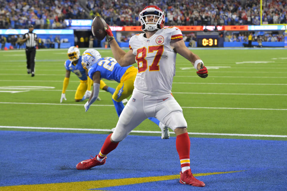 Kansas City Chiefs tight end Travis Kelce, right, celebrates a touchdown as Los Angeles Chargers safety Derwin James Jr., left, and cornerback Bryce Callahan get up off the ground during the second half of an NFL football game Sunday, Nov. 20, 2022, in Inglewood, Calif. (AP Photo/Jayne Kamin-Oncea)