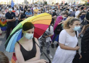 LGBT rights supporters protest in Warsaw, Poland, Saturday, Aug. 8, 2020. A large crowd of LGBT rights supporters gathered in Warsaw on Saturday to protest the arrest of a transgender activist who had carried out acts of civil disobedience against rising homophobia in Poland. (AP Photo/Czarek Sokolowski)