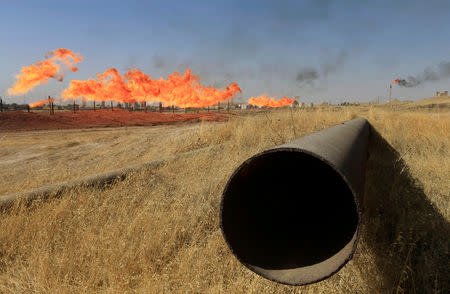 FILE PHOTO: Flames emerge from flare stacks at oilfields in Kirkuk, Iraq October 18, 2017. REUTERS/Alaa Al-Marjani/File Photo