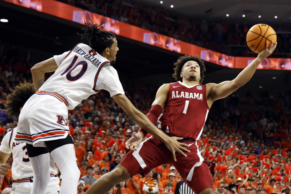 Alabama guard Mark Sears (1) puts up a shot around Auburn guard Chad Baker-Mazara (10) during the first half of an NCAA college basketball game, Wednesday, Feb. 7, 2024, in Auburn, Ala. (AP Photo/Butch Dill)