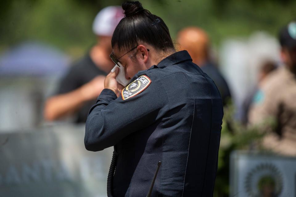 An officer for the Uvalde school district wipes a tear at the end of a news conference Friday on the law enforcement response to the Tuesday mass shooting at a Uvalde elementary school.