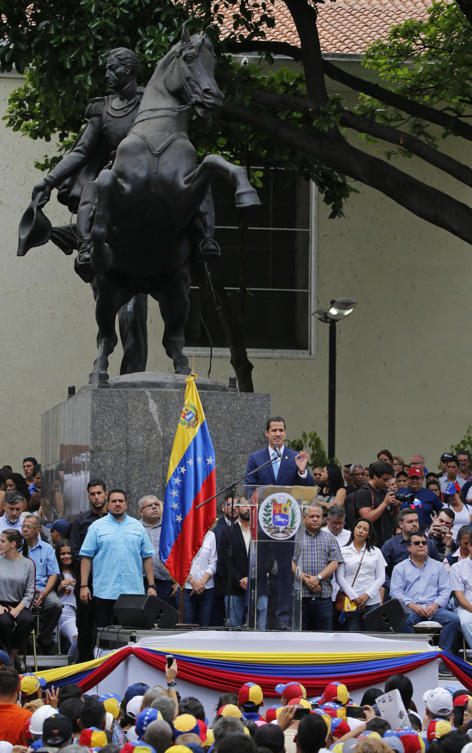 Juan Guaido, opposition leader and self-proclaimed interim president of Venezuela, leads an outdoor, town hall-style meeting in Plaza Bolivar in the Chacao area of Caracas, Venezuela, Friday, April 19, 2019. The opposition held the forum to announce a new strategy against the government of President Nicolas Maduro. (AP Photo/Fernando Llano)