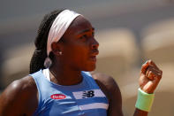 Coco Gauff of the U.S. clenches her fist after scoring a point against Poland's Iga Swiatek during their quarterfinal match of the French Open tennis tournament at the Roland Garros stadium in Paris, Wednesday, June 7, 2023. (AP Photo/Christophe Ena)