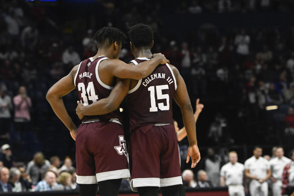 Texas A&M forward Julius Marble (34) and forward Henry Coleman III console in the final moments of an NCAA college basketball game against Texas A&M in the finals of the Southeastern Conference Tournament, Sunday, March 12, 2023, in Nashville, Tenn. Alabama won 82-63. (AP Photo/John Amis)
