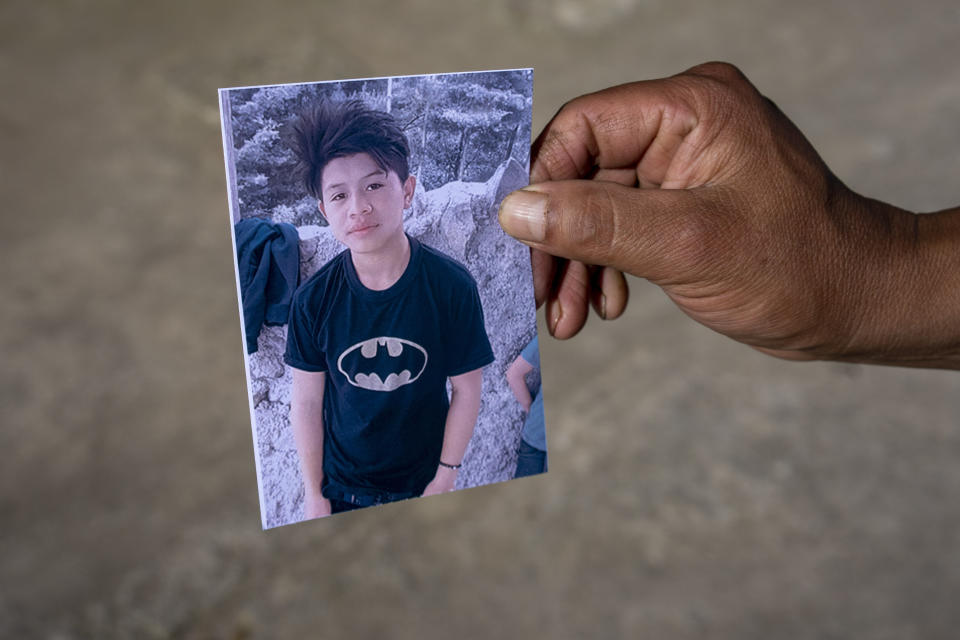 A man shows a portrait of Wilmer Tulul, in Tzucubal, Guatemala, Wednesday, June 29, 2022. Wilmer and his cousin Pascual, both 13, were among the dead discovered inside a tractor-trailer near auto salvage yards on the edge of San Antonio, Texas, on Monday, in what is believed to be the nation's deadliest smuggling episode on the U.S.-Mexico border. (AP Photo/Moises Castillo)