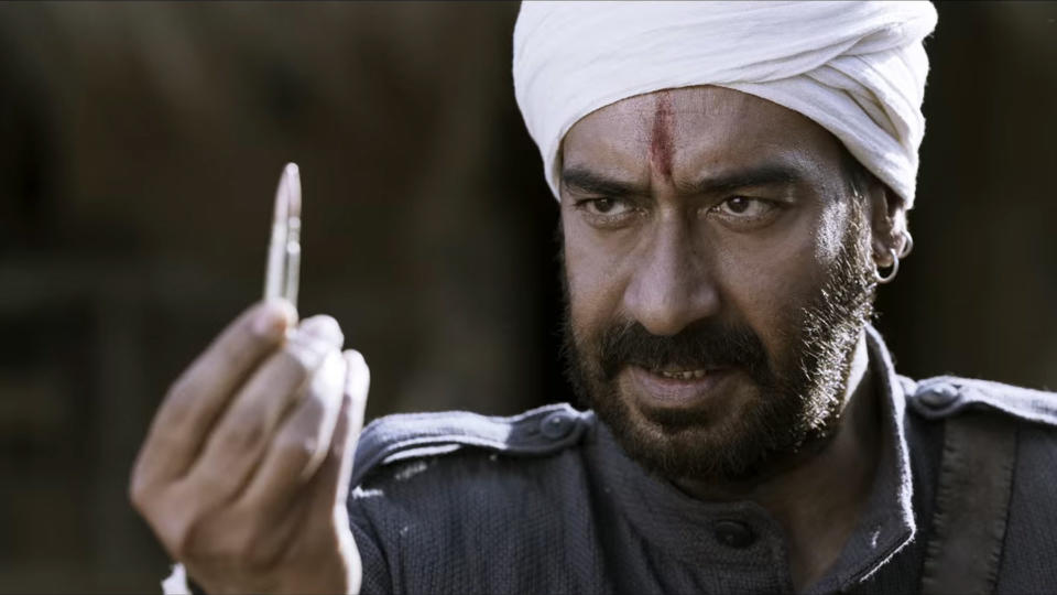 Alluri Sitarama Raju holds up a bullet