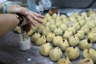 An employee makes anti-extradition bill mooncakes at Wah Yee Tang Bakery in Hong Kong