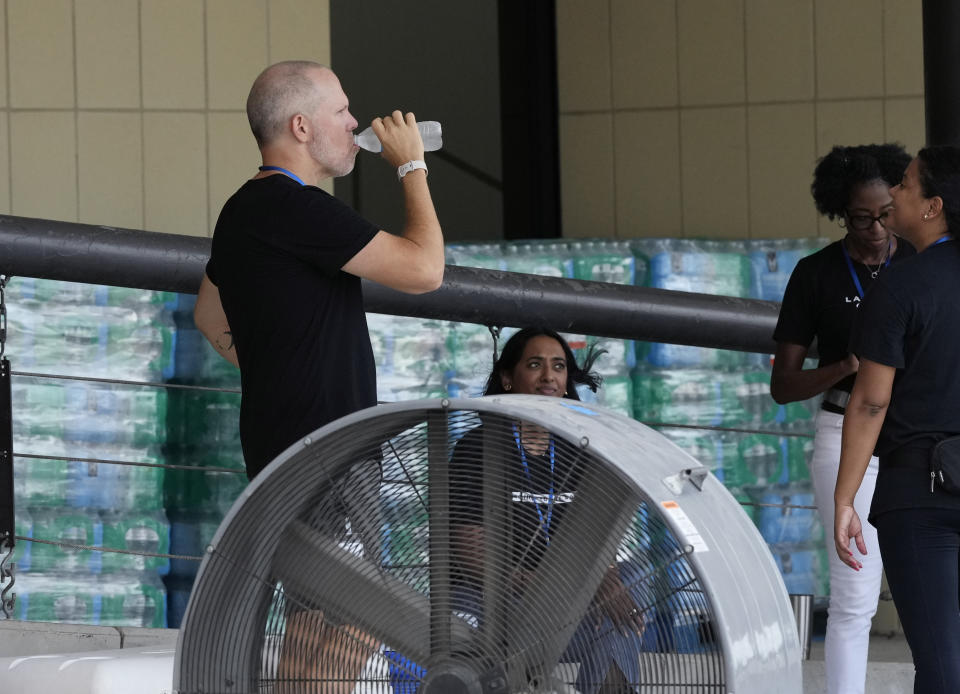 Staff at Lakewood Church operate a cooling station and water distribution line in Houston, Tuesday, July 9, 2024. The effects of Hurricane Beryl left most in the area without power. (AP Photo/Eric Gay)