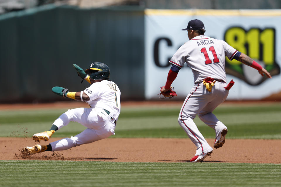 Oakland Athletics' Esteury Ruiz (1) is tagged out by Atlanta Braves shortstop Orlando Arcia (11) on a steal attempt during the first inning of a baseball game in Oakland, Calif., Thursday, May 31, 2023. (AP Photo/Jed Jacobsohn)