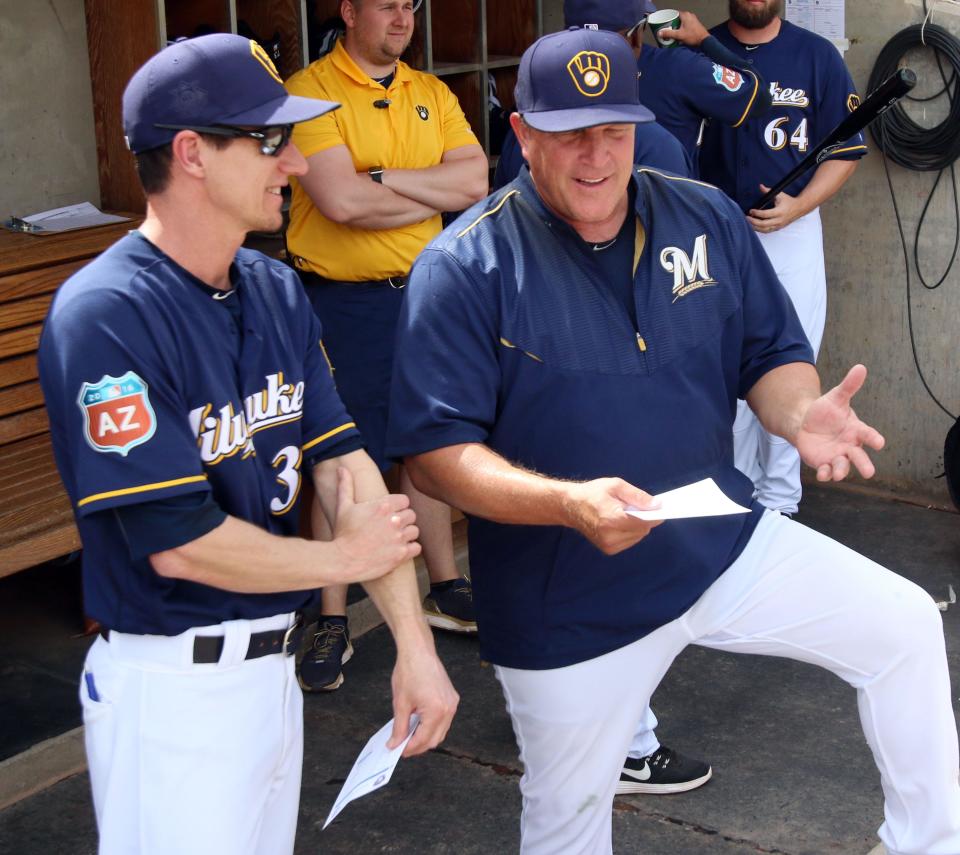 Milwaukee Brewers Manager Craig Counsell (left) talks with Bench Coach Pat Murphy prior to their spring training game against the Texas Rangers on March 11, 2016, in Phoenix, Arizona.