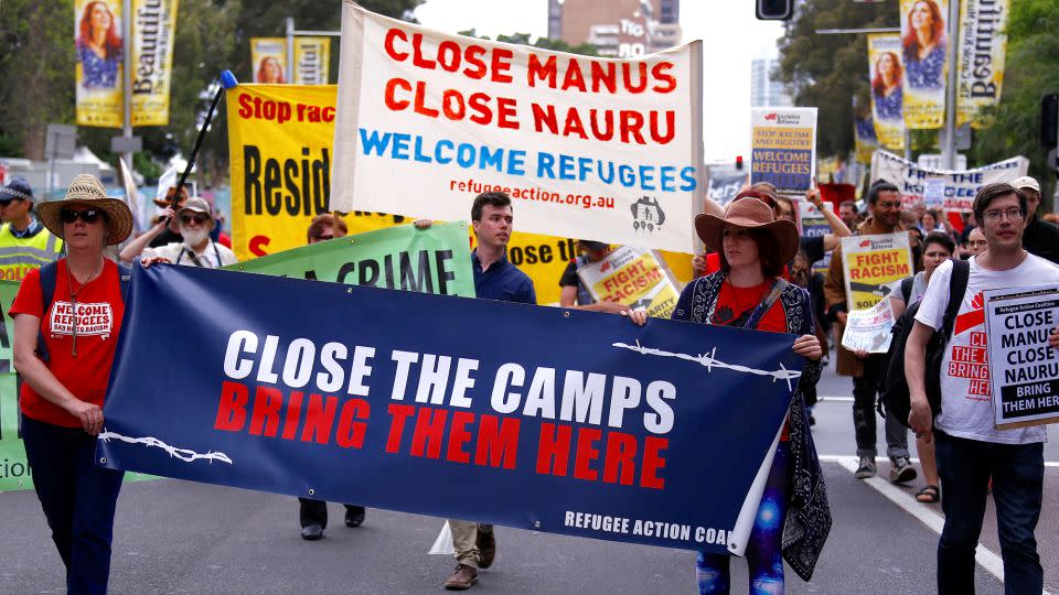 In 2017, refugee advocates hold placards as they protest in central Sydney, Australia, against the treatment of asylum seekers in detention centers in Nauru and on Manus Island. - David Gray/Reuters