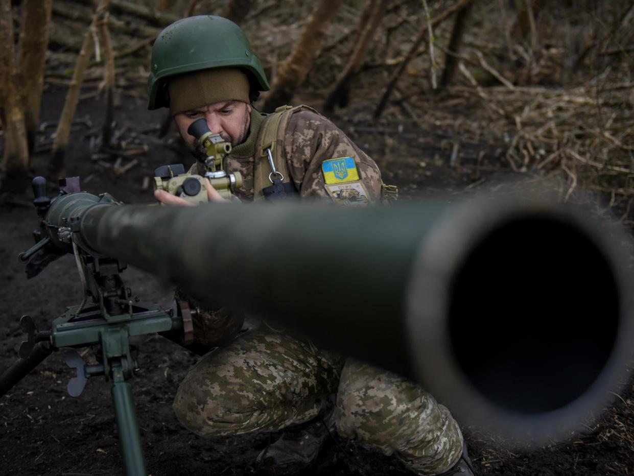Ukrainian serviceman fires a howitzer (EPA)