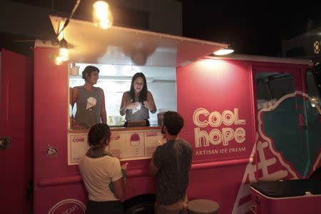 People buy ice cream at a food truck in San Juan, Puerto Rico, November 3, 2016. Picture taken November 3, 2016. REUTERS/Alvin Baez