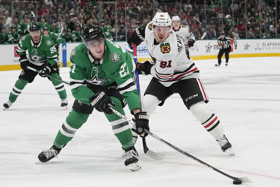 Dallas Stars left wing Mason Marchment (27) and Chicago Blackhawks wing Anthony Beauvillier (91) skate for the puck during the first period of an NHL hockey game in Dallas, Friday, Dec. 29, 2023. (AP Photo/LM Otero)