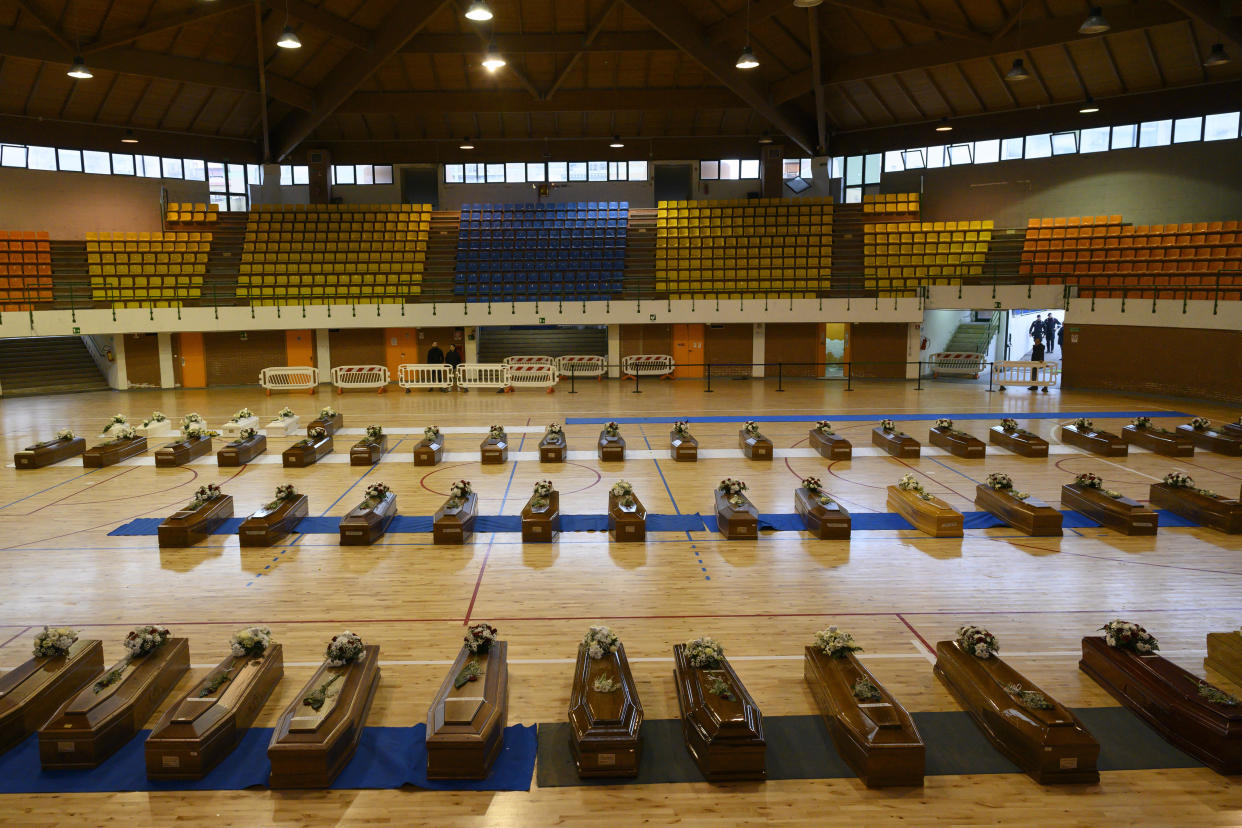 Victims of a migrants boat shipwreck lay in state in a sports centre where they were taken, in Crotone, southern Italy, Tuesday, Feb. 28, 2023. Nearly 70 people died in last week's shipwreck on Italy's Calabrian coast. The tragedy highlighted a lesser-known migration route from Turkey to Italy for which smugglers charge around 8,000 euros per person. (AP Photo/Valeria Ferraro, File)