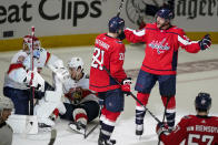 Washington Capitals right wing Garnet Hathaway and center Nic Dowd, right, celebrate Hathaway's goal past Florida Panthers goaltender Sergei Bobrovsky, left, during the third period of Game 3 in the first-round of the NHL Stanley Cup hockey playoffs, Saturday, May 7, 2022, in Washington. The Capitals won 6-1. (AP Photo/Alex Brandon)