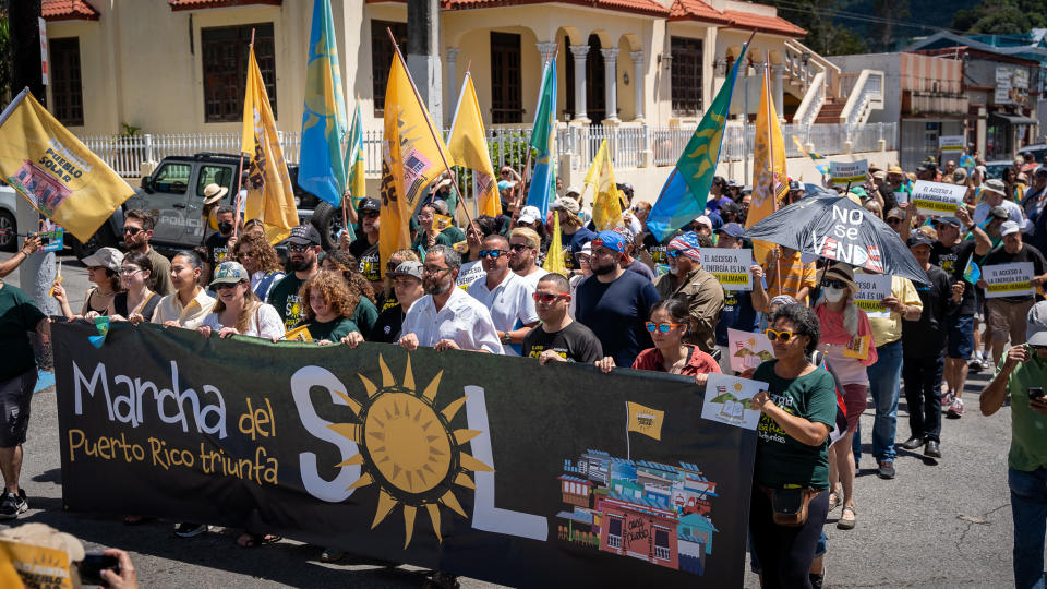 Residents in Adjuntas, Puerto Rico, celebrate the launch of a community-owned solar microgrid on March 18, 2023.<span class="copyright">Peter Walle, Honnold Foundation</span>