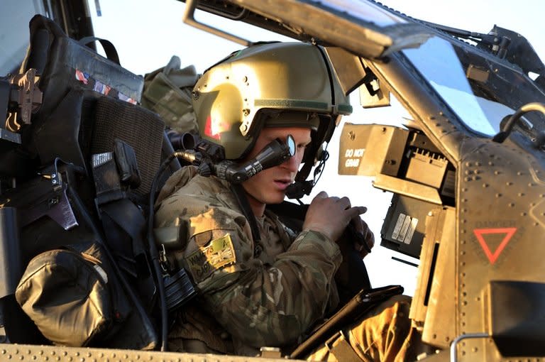 Britain's Prince Harry does a systems check in the cockpit of his Apache helicopter, November 2, 2012, at Camp Bastion in Afghanistan's Helmand Province. Harry said he killed Taliban fighters during his stint as a helicopter gunner in Afghanistan, in comments that can be reported after he completed his tour of duty Monday