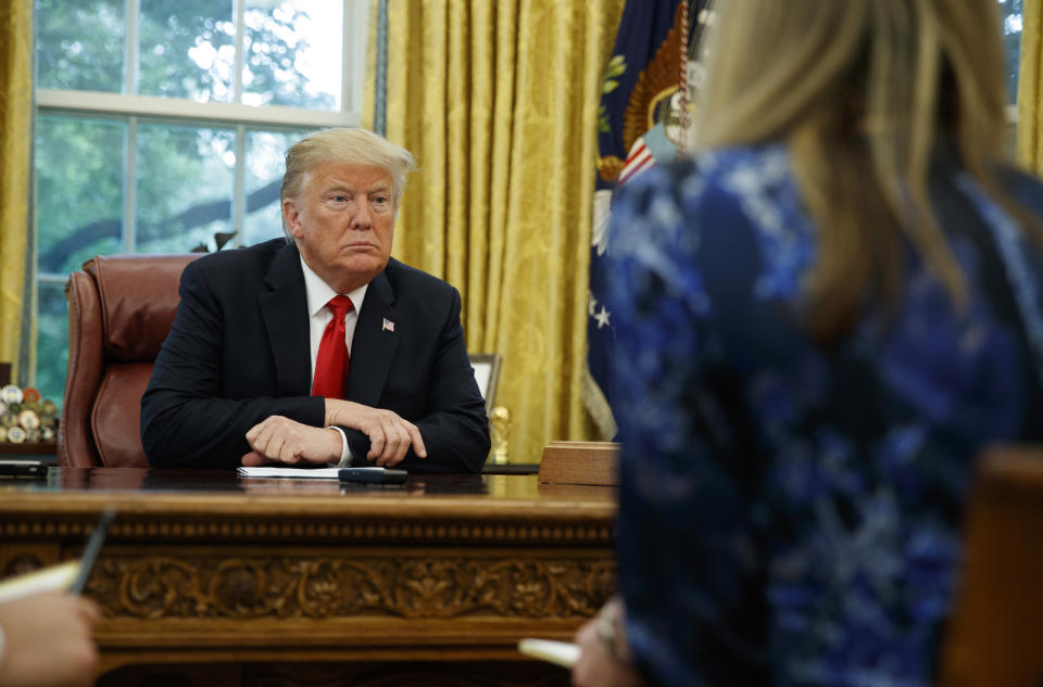 President Donald Trump listens to a question during an interview with The Associated Press in the Oval Office of the White House, Tuesday, Oct. 16, 2018, in Washington. (AP Photo/Evan Vucci)