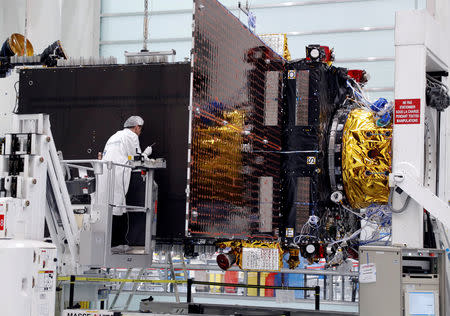 FILE PHOTO: Technicians work on the Inmarsat S-Band/Hellas-Sat 3 satellite in the clean room facilities of the Thales Alenia Space plant in Cannes, France, February 3, 2017. REUTERS/Eric Gaillard/File Photo