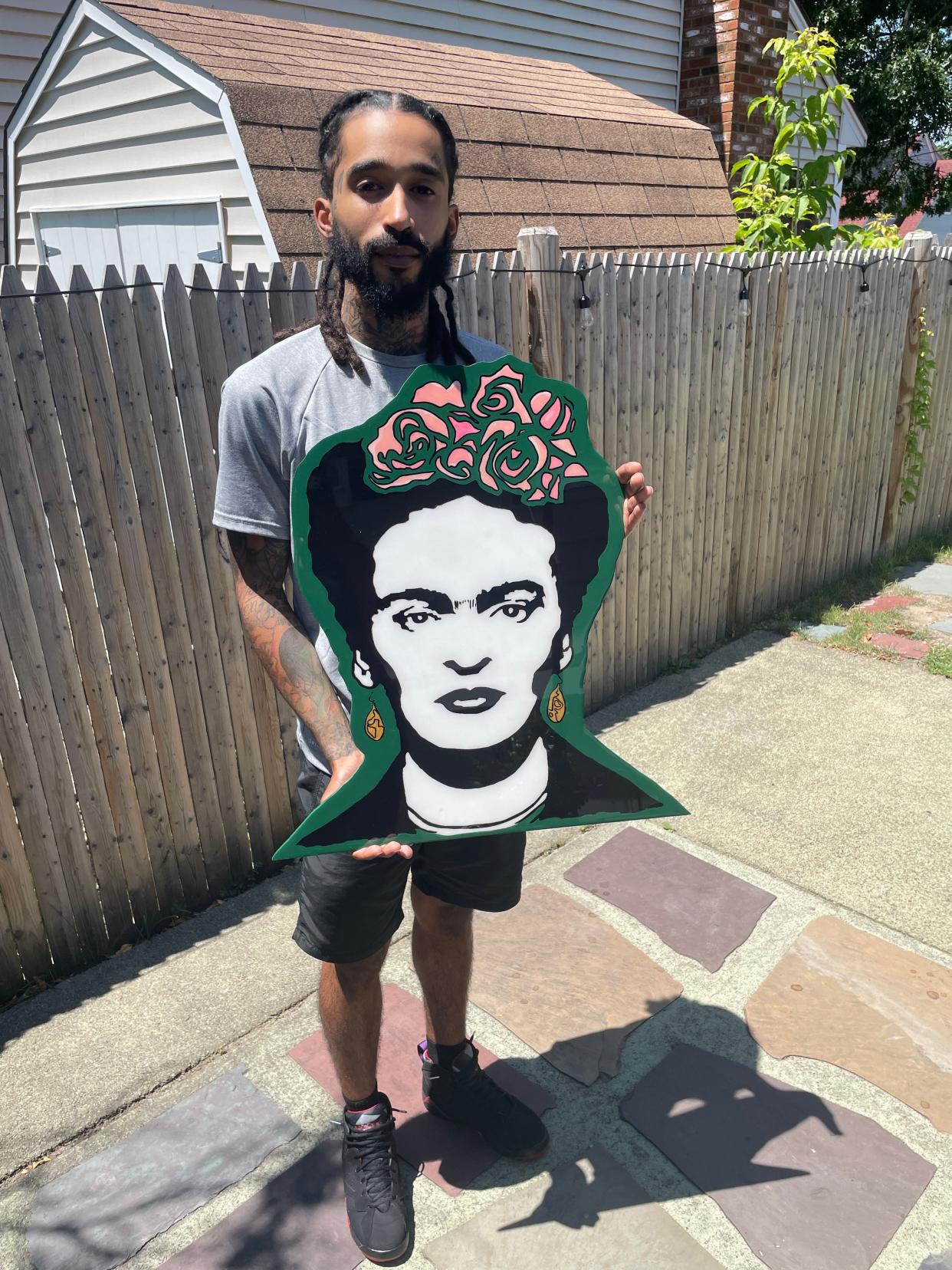 Mason Reverdes, 28, a self-taught artist with a piece he created with wood and epoxy resin. Reverdes started his art business QuarterKey.Us during the pandemic to elevate himself.