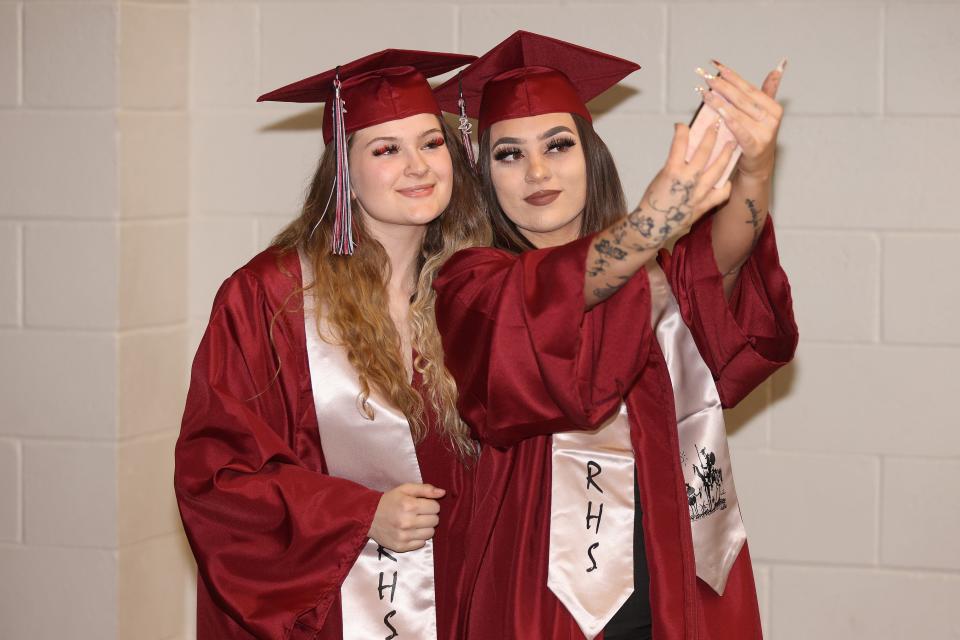 Rocinante High School Seniors Jacelynn Ledford (left) and Destinee Finly (right) take a selfie while waiting in the Scorpion Arena prior to the start of the commencement exercises on Wednesday, May 18. 