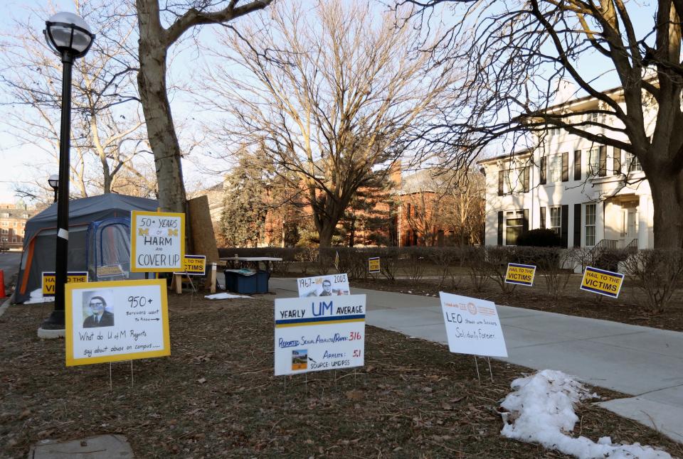 Protest signs in front of the home of former University of Michigan president Mark Schlissel on Sunday, Jan.16, 2022.