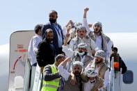 Freed Houthi prisoners arrive after their release in a prisoner swap, in Sanaa airport