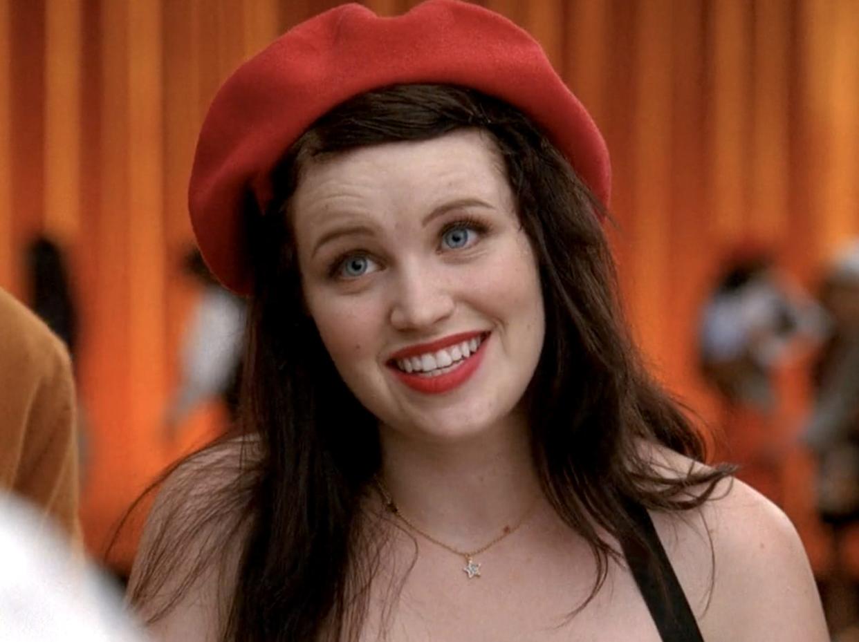 Lindsay Pearce wearing a red hat on Glee