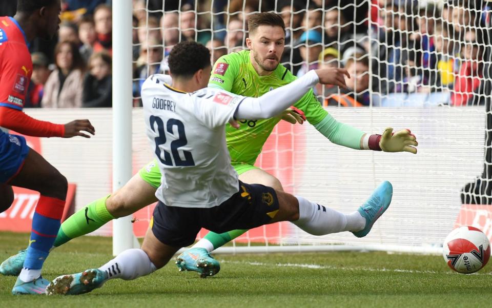 Jack Butland of Crystal Palace attempts to save as Ben Godfrey of Everton stretches for the ball - Tom Dulat/Getty Images