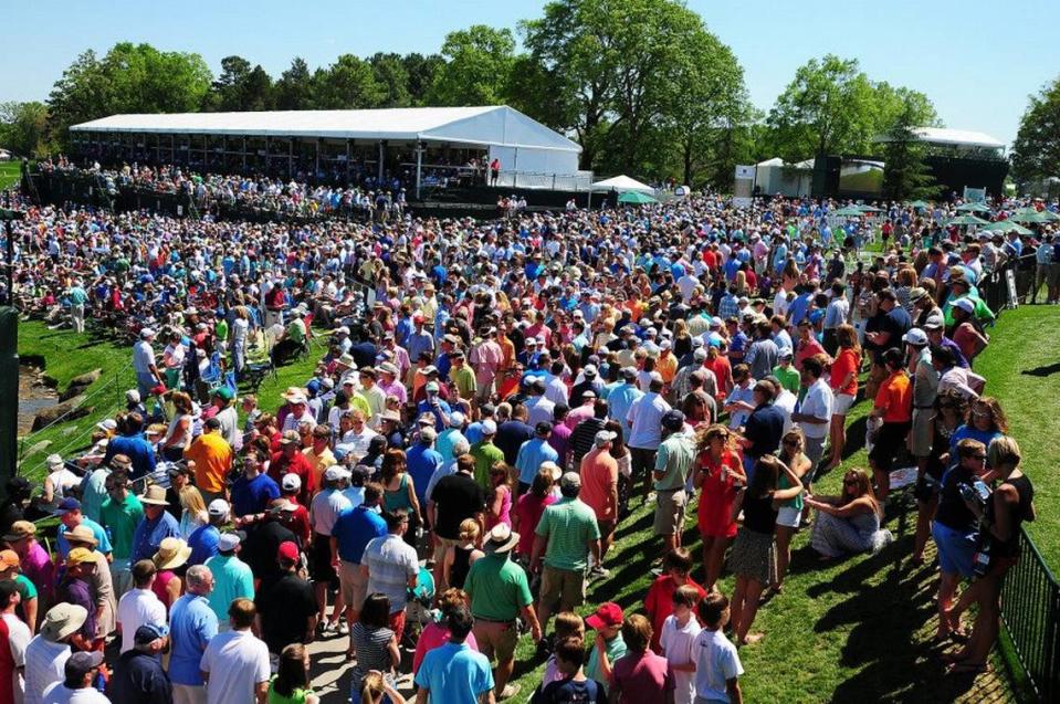 Fans crowd around the 18th green during the Wells Fargo Championship at Quail Hollow Club.