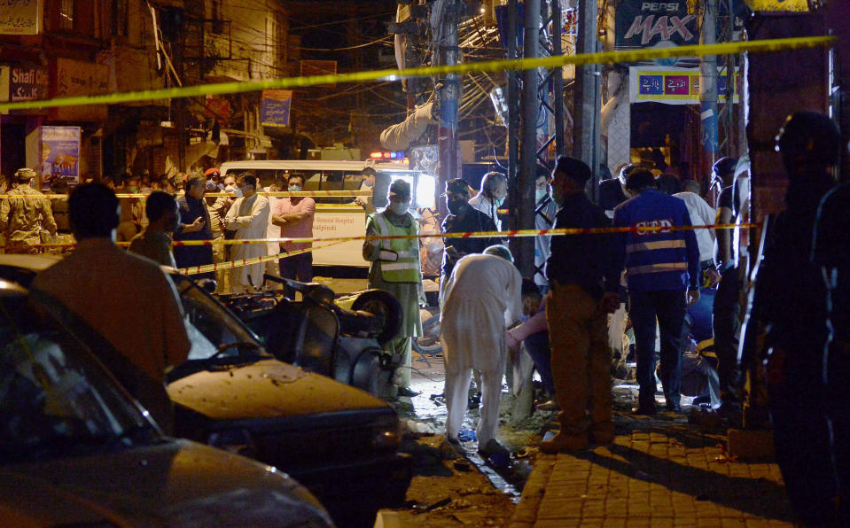 Pakistan's security officials examine the site of a bomb explosion that ripped through a bazaar in Rawalpindi, Pakistan, Friday, June 12, 2020.(AP Photo/A.H. Chaudary)