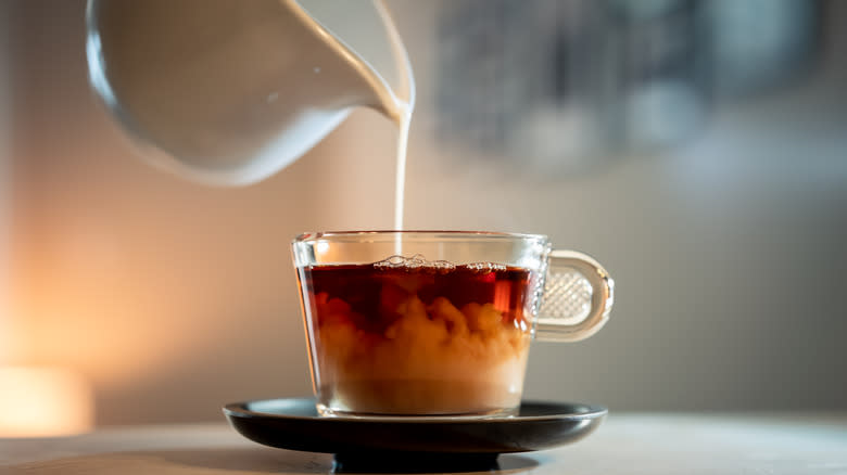 pouring tea into teacup