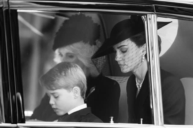 <p>Samir Hussein/WireImage</p> Prince George of Wales, Camilla, Queen Consort and Catherine, Princess of Wales during the State Funeral of Queen Elizabeth II at Westminster Abbey on September 19, 2022.