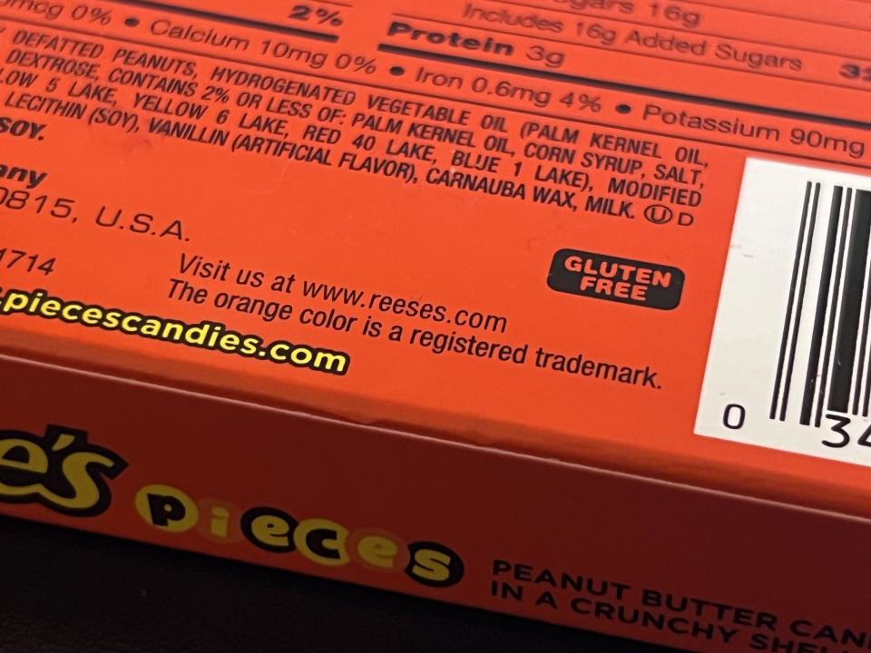 Close-up of the Reese's candy wrapper saying, "The orange color is a registered trademark"