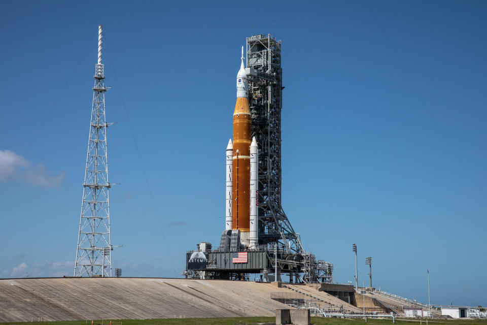 The Space Launch System moon rocket atop pad 39B at the Kennedy Space Center for a dress rehearsal countdown and fueling test earlier this year. NASA plans to roll the rocket back to the pad overnight Tuesday to prepare the huge booster for its maiden launch on August 29. / Credit: NASA file photo