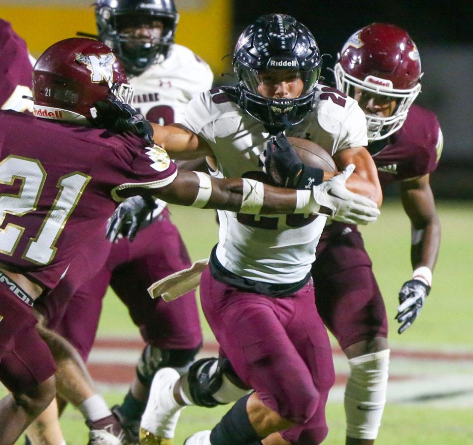 Navarre RB Connor Mathews powers though defenders during the Niceville Navarre football game at Niceville.