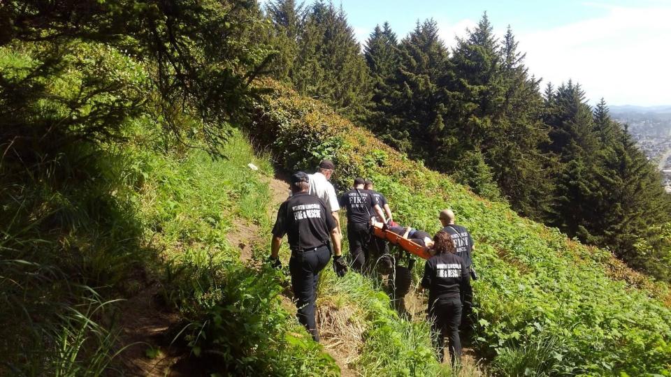 A Coast Guard helicopter and rescue teams conduct a rescue operation at God's Thumb north of Lincoln City earlier this year.