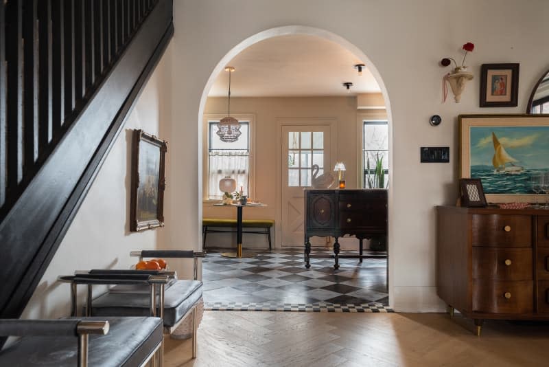 View into the kitchen from the living room with wooden floors.