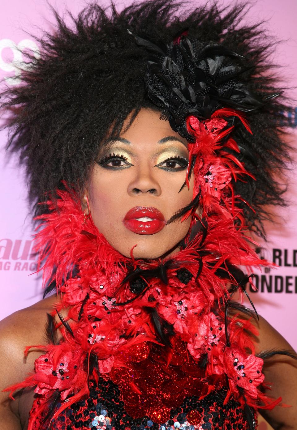 Headshot of Bebe Zahara Benet with a red feather boa