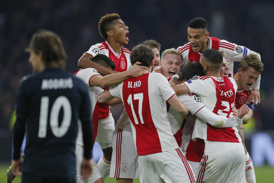 Ajax's Nicolas Tagliafico celebrates with his teammates after scoring his side's opening goal and the goal was disallowed after a review by VAR during the first leg, round of sixteen, Champions League soccer match between Ajax and Real Madrid at the Johan Cruyff ArenA in Amsterdam, Netherlands, Wednesday Feb. 13, 2019. (AP Photo/Peter Dejong)
