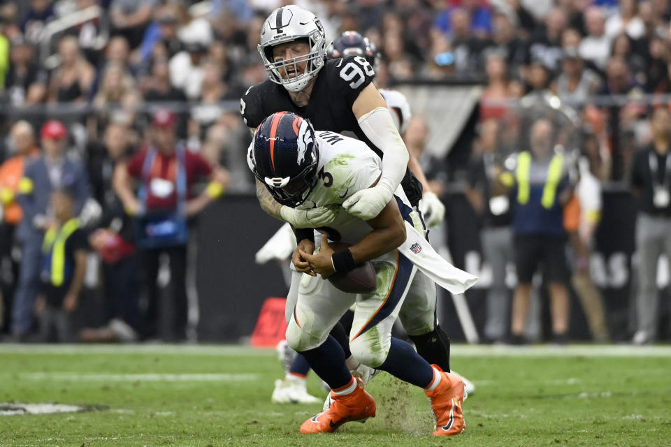 Las Vegas Raiders defensive end Maxx Crosby (98) sacks Denver Broncos quarterback Russell Wilson (3) during the second half of an NFL football game, Sunday, Oct. 2, 2022, in Las Vegas. (AP Photo/David Becker)