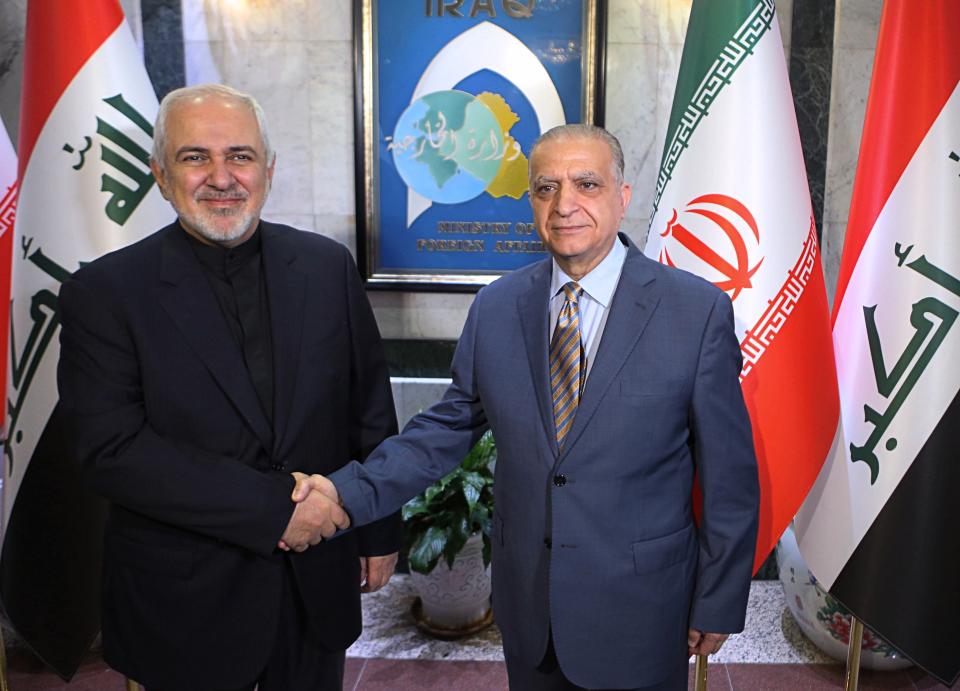 Iraqi Foreign Minister Mohamed Alhakim, right, shakes hands with his visiting Iranian counterpart Mohammad Javad Zarif at the Ministry of Foreign Affairs Building in Baghdad, Iraq, Sunday, May 26, 2019. (AP Photo/Khalid Mohammed)