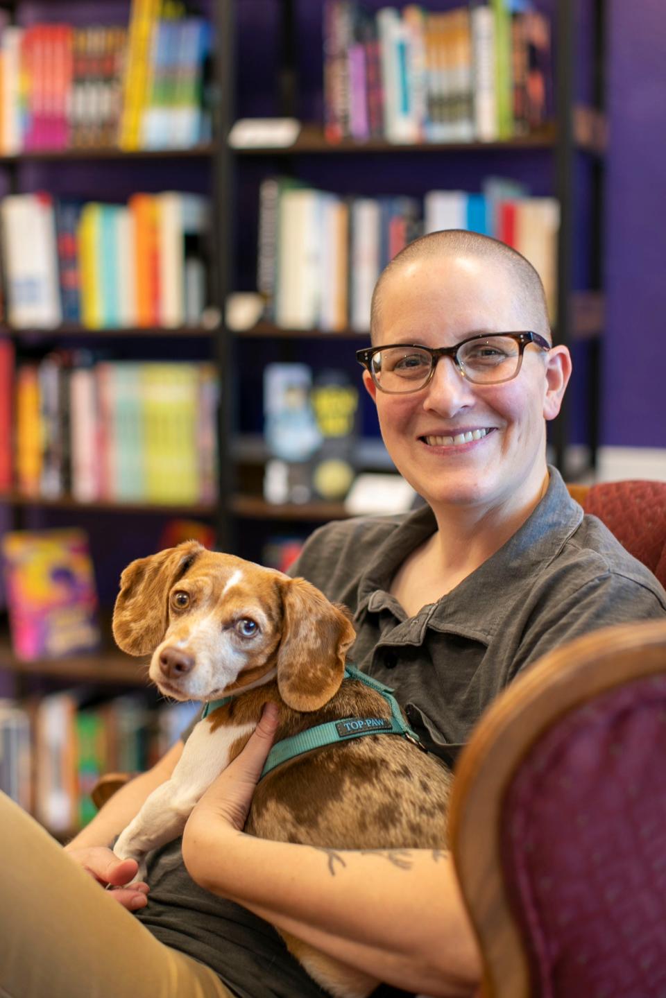 Kelly D. Holstine owner of WordHaven BookHouse poses with one of her dogs at the bookstore, Friday, September 9, 2022, in Sheboygan, Wis.